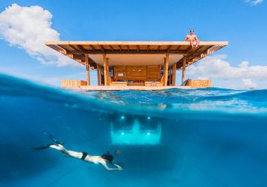 An image of a man swimming in the ocean, Sleep Under The Sea in Tanzania. The Manta Resort