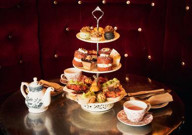 An image of a table with a cake stand, Bottomless Afternoon Tea. Map Maison
