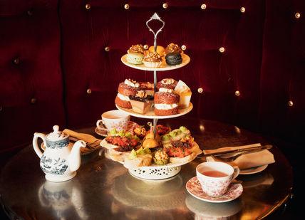 An image of a table with a cake stand, Bottomless Afternoon Tea. Map Maison