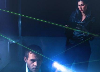 An image of a man and woman in a room with laser lights, Capital Caper Escape Room Adventure. Mazer Zone