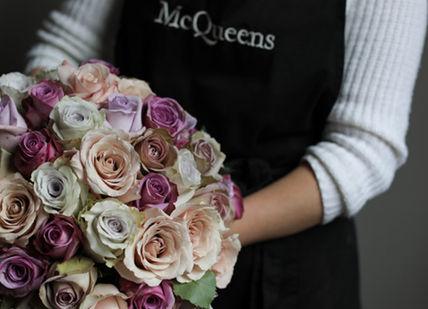 An image of a woman holding a bouquet of flowers, Hand-Tied Bouquet Workshop. McQueens
