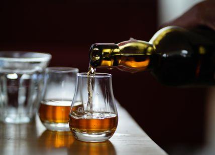 An image of a person pouring a drink, Premium Irish Whiskey Tasting. Merchant House