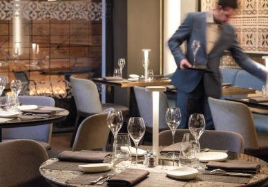 An image of a restaurant setting with a waiter, Six-Course Tasting Menu. Mere Restaurant