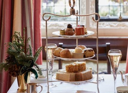An image of a table with a tray of food, Royal Afternoon Tea. The Milestone Hotel