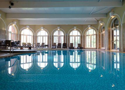An indoor swimming pool in a large building.