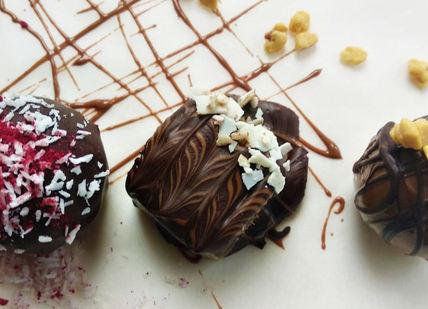 An image of chocolates and nuts on a white surface, Online Chocolate Truffle Masterclass. Mychocolate