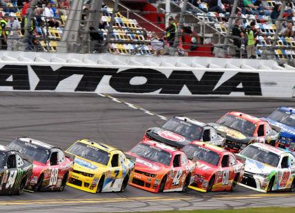 An image of a race track with cars racing, Private NASCAR Experience with Daytona 500 Winner. NASCAR Racing