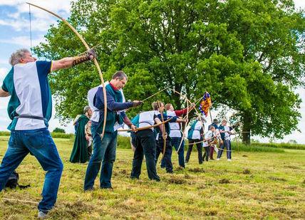 An image of a group of people in a field, Immersive Archery Experience. Now Strike Archery