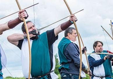 An image of a group of people holding flags, Immersive Archery Experience. Now Strike Archery
