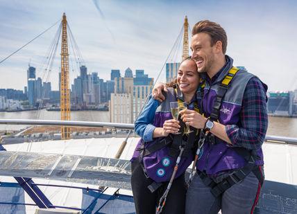 An image of a man and woman on a boat, Submit The O2 wiith a Champagne on the roof. THE O2