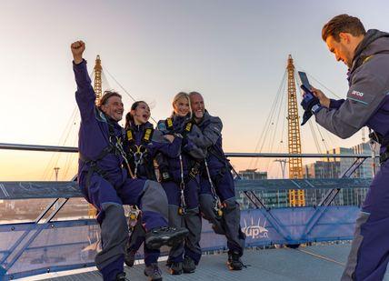 An image of a group of people on a bridge, Submit The O2 wiith a Champagne on the roof. THE O2