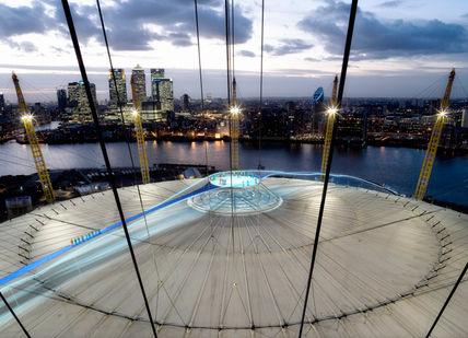 An image of a city at night, Submit The O2 wiith a Champagne on the roof. THE O2