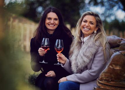An image of two women drinking wine, Vineyard Tour And Wine Tasting. Oastbrook Estate