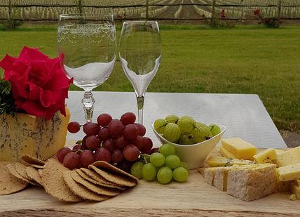An image of a table with cheese and grapes, Vineyard Tour And Wine Tasting. Oastbrook Estate