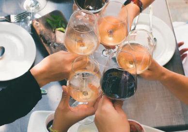 An image of people toasting wine glasses, Bottomless Rosé Afternoon Tea. Oblix