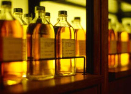 An image of bottles of alcohol on a shelf, Return Collection from Hotel in Tokyo. Oishii Tours