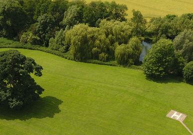 An image of a field with trees and a river, Head Office. PhantomFlightSchool