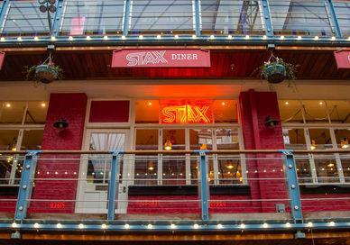 An image of a restaurant with red walls and a balcony, Full Day Rock Music Tour. Premium Tours