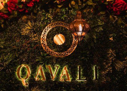 An image of a floral wreath with candles and candles, Champagne afternoon tea. Qavali