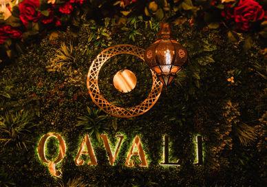 An image of a floral wall with candles and candles, Wine Pairing Lunch at Qavali. Qavali