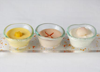An image of three candles on a tray, Six-Course Seafood Tasting Menu. Quilon