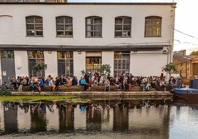 An image of people standing on the water, The car park outside of Crate Brewery. The Rambling Beer Co