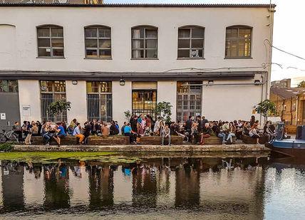 An image of people standing on the water, The car park outside of Crate Brewery. The Rambling Beer Co