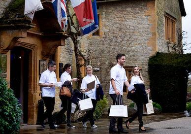 An image of a group of people walking in the rain, Weekend Full-day Cookery Course. Le Manoir aux Quat'Saisons, A Belmond Hotel