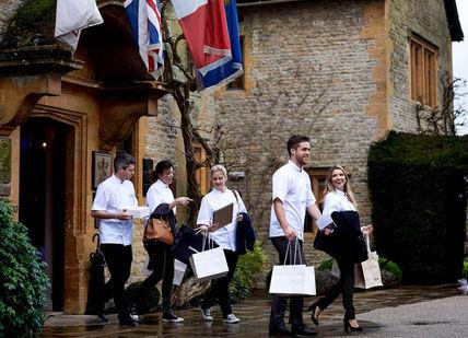 An image of a group of people walking in the rain, Weekend Full-day Cookery Course. Le Manoir aux Quat'Saisons, A Belmond Hotel