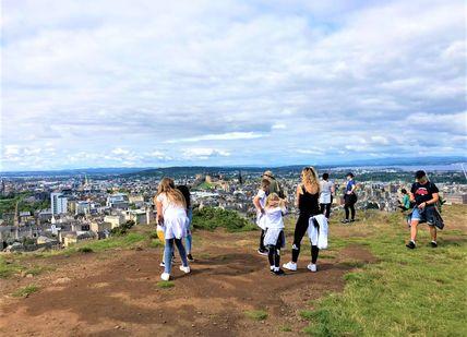 An image of a group of people on a hill, Private Hike to the Top of Arthur’s Seat. Rishi's Edinburgh Tours