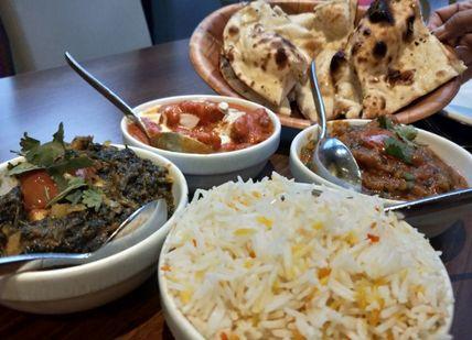 An image of a table with bowls of food, Private Royal Mile Old Town Tour and Indian Dinner. Rishi's Edinburgh Tours