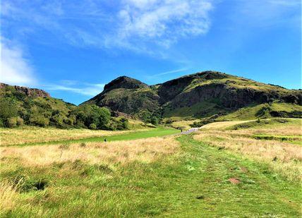 An image of a grassy hill with a blue sky, Private Scottish Highlands Nature Tour. Rishi's Edinburgh Tours