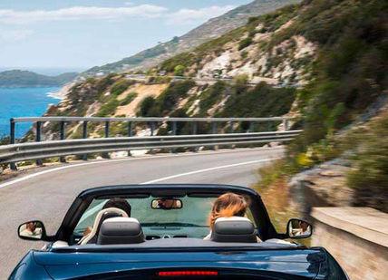 An image of a blue convertible driving down a road, Heaven In Mallorca Romantic Getaway Tour. On The Road- Spain
