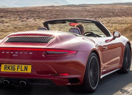 An image of a red porsche convertible driving down a road, Pure Spain Self Driving Holiday. On The Road- Spain