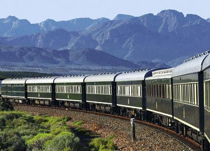 An image of a train going through the mountains, Pretoria to Victoria Falls by Train. Rovos Rail