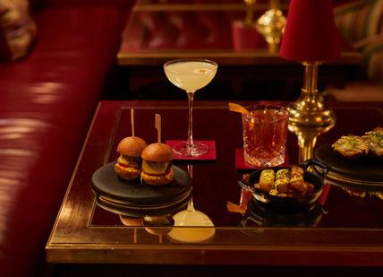 An image of a table with food and drinks, Royal cocktails and sharing platter. The Rubens at the Palace - The New York Bar