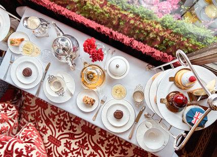 An image of a table setting with a variety of food, Royal Afternoon Tea. The Rubens at the Palace - The Palace Lounge