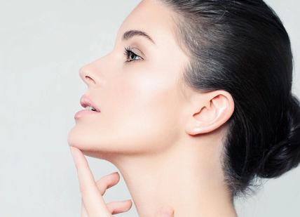 An image of a woman with her hand on her chin, Skin Clarity Treatment. Santi Spa London