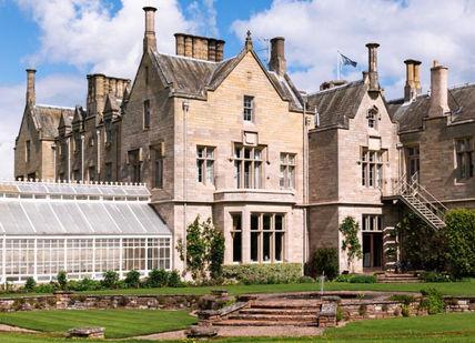 An image of a large house with a glass roof, Outdoor Country Sporting Retreat in Rural Scotland. SCHLOSS Roxburghe Hotel
