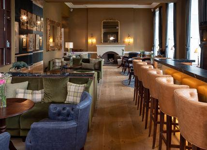 An image of a hotel lobby with a bar, Outdoor Country Sporting Retreat in Rural Scotland. SCHLOSS Roxburghe Hotel