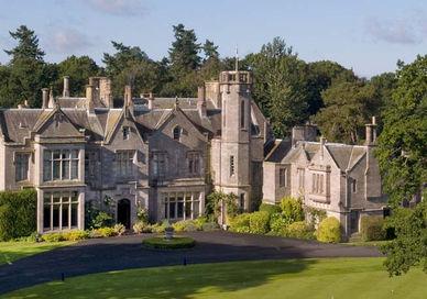 An image of a large house in the middle of a field, Scottish Golf Getaway. SCHLOSS Roxburghe Hotel