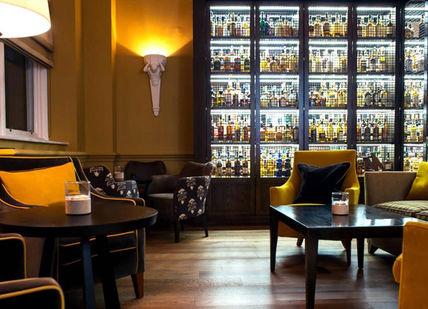 An image of a bar with a lot of bottles, 100 Years of Whisky Journey. Scotch at The Balmoral