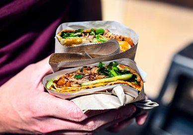 An image of a person holding a taco, London Bridge Secret Food Tour. Secret Food Tours