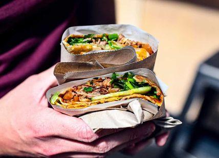 An image of a person holding a taco, London Bridge Secret Food Tour. Secret Food Tours