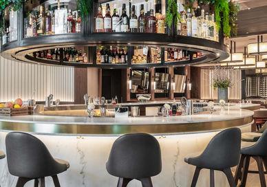 An image of a bar with a bar stools, Sette. Sette