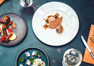An image of a table with plates of food, Exclusive Tasting Menu with Wine Pairing. Shears Yard
