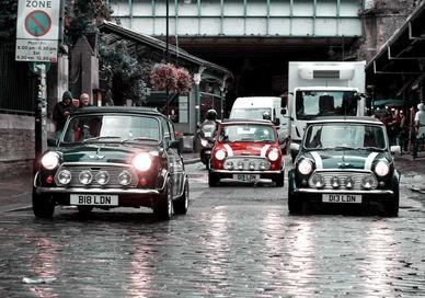 An image of a street with old cars, Explore London By Night in a Classic Mini Cooper. smallcarBIGCITY