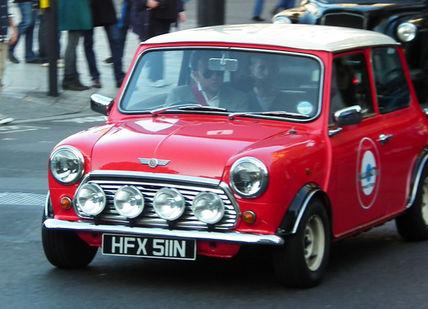 An image of a mini car driving down the street, Iconic London Tour in a Classic Mini Cooper. smallcarBIGCITY