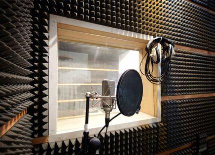 An image of a microphone in a recording room, 1 hour Music Lesson. The Soho Music School