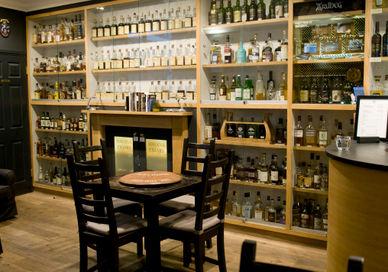 An image of a bar with many bottles of alcohol, Soho Whisky Club. Soho Whisky Club